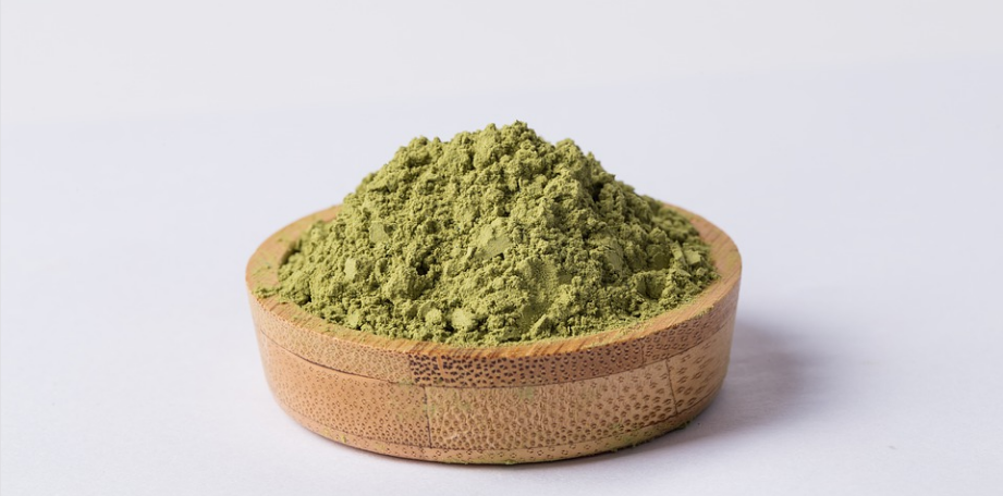 green powder in a wooden container