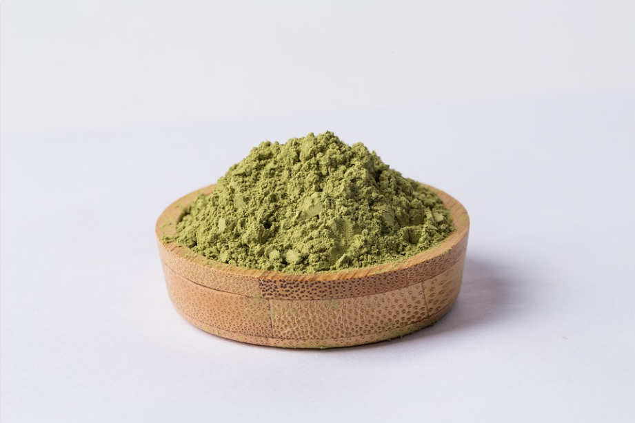 green powder in a wooden container